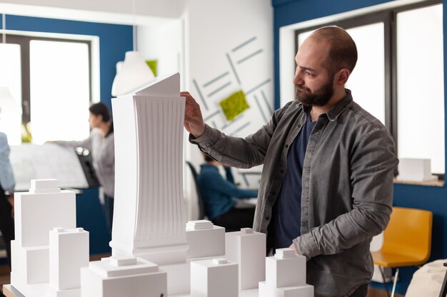 Architect man looking at design in professional office