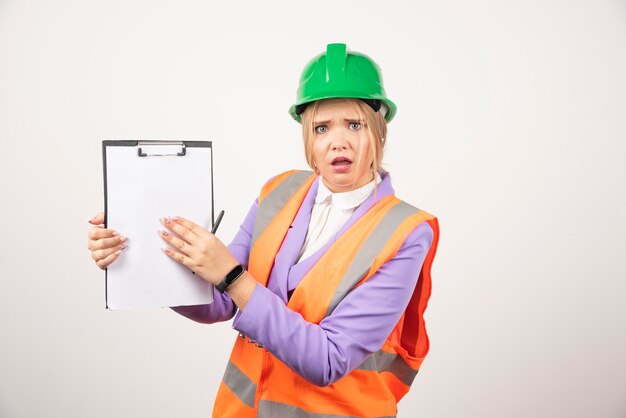 architect woman in hardhat with tablet on white.