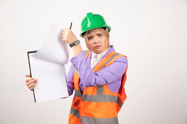 architect woman in hardhat with tablet on white.