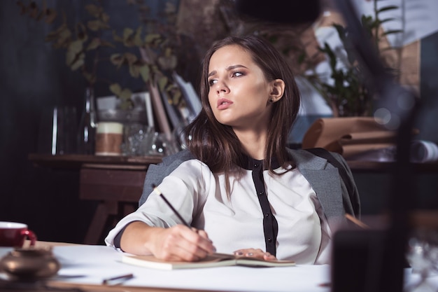 Free photo architect woman working on drawing table in office