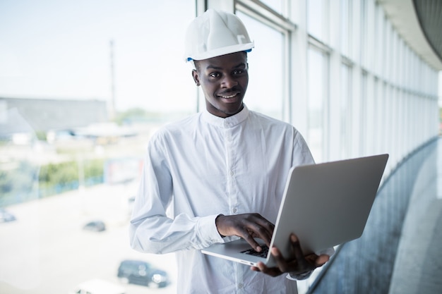 Architect working with computer and blueprints in office