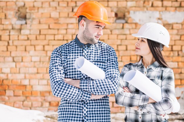 Architects in front of brick wall