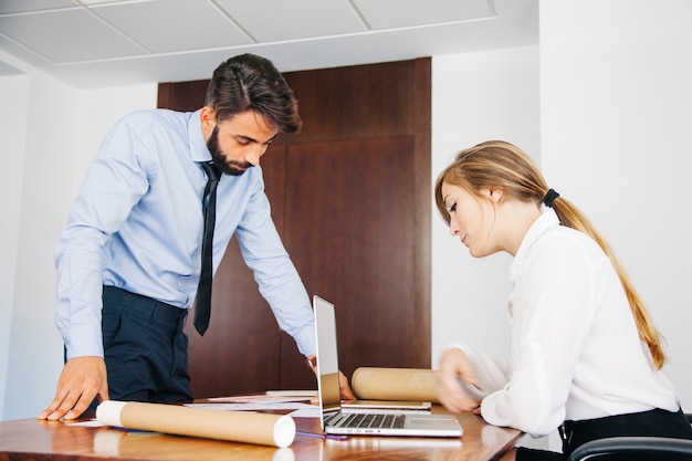 Architects looking at documents on desk