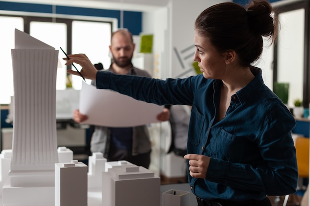 Architecture office partners looking at blueprints and plans