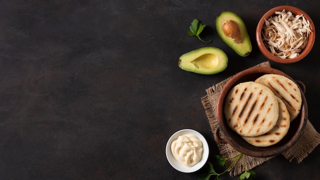 Free photo arepas and avocado frame flat lay