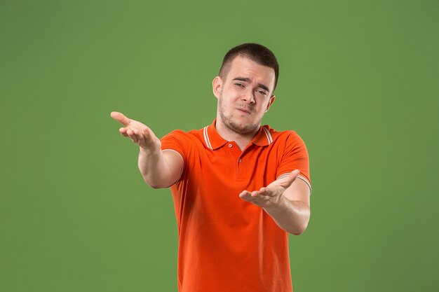 Argue, arguing concept. Beautiful male half-length portrait isolated on green studio