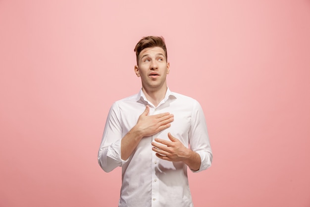 Argue, arguing concept. Beautiful male half-length portrait isolated on pink studio