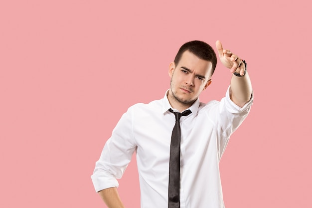 Argue, arguing concept. Male half-length portrait isolated on orange studio backgroud. Young emotional surprised man looking at camera.  Front view