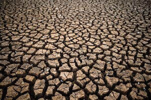 Arid land with dry and cracked ground, global warming