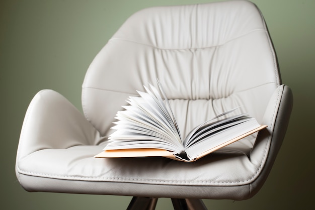 Free photo armchair with open book