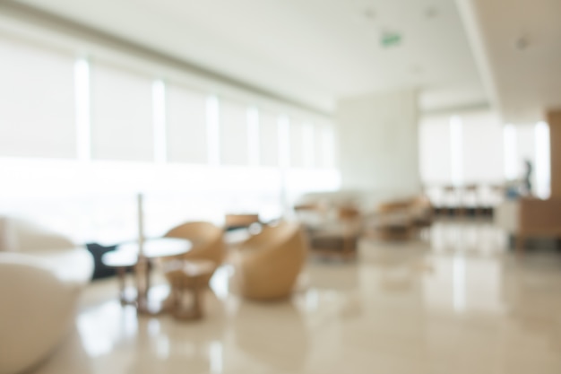 Armchairs surrounding circular tables unfocused