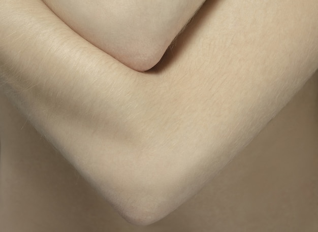 Arms. Detailed texture of human skin. Close up shot of young caucasian female body.