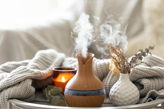 Free photo aroma composition with a modern aroma oil diffuser and a knitted element