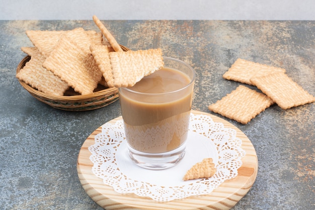 Aroma cup of coffee with crackers on marble background. High quality photo