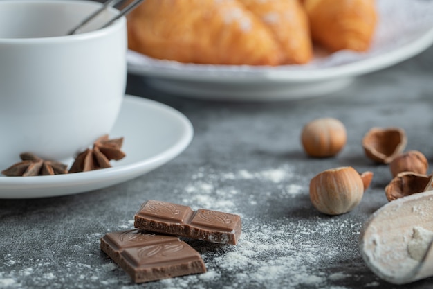 Aroma cup of tea with delicious croissants.