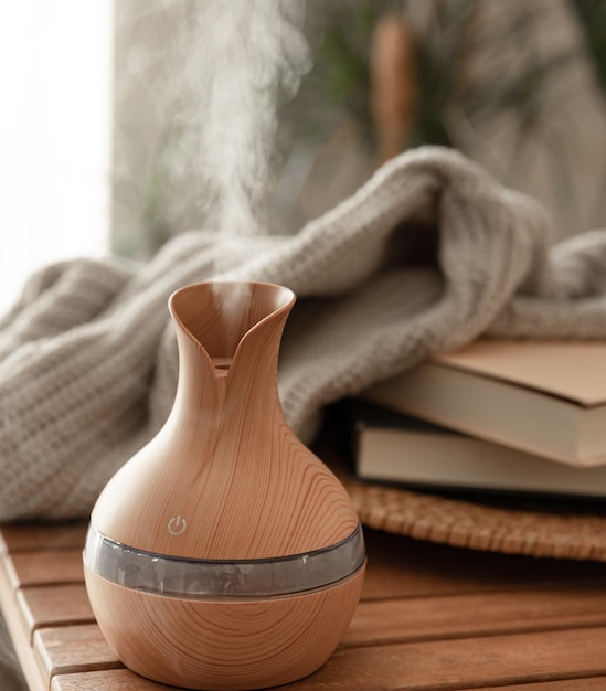 Free photo aroma oil diffuser lamp on a blurred background in the interior of the room