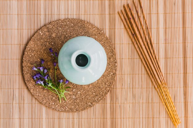 Aroma sticks and flowers near vase