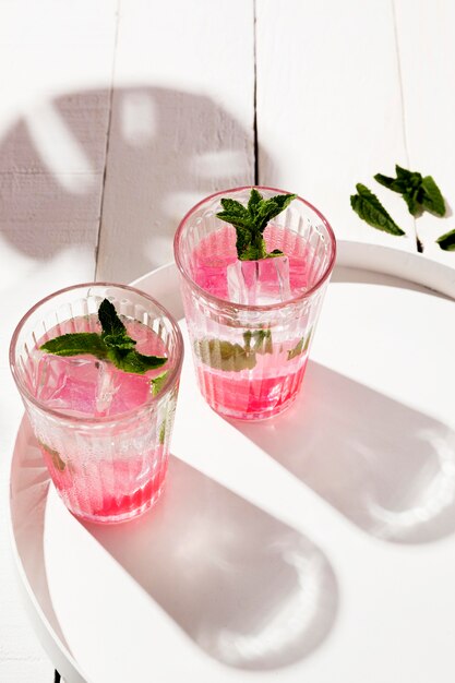 Aromatic ice cold drink glasses on desk