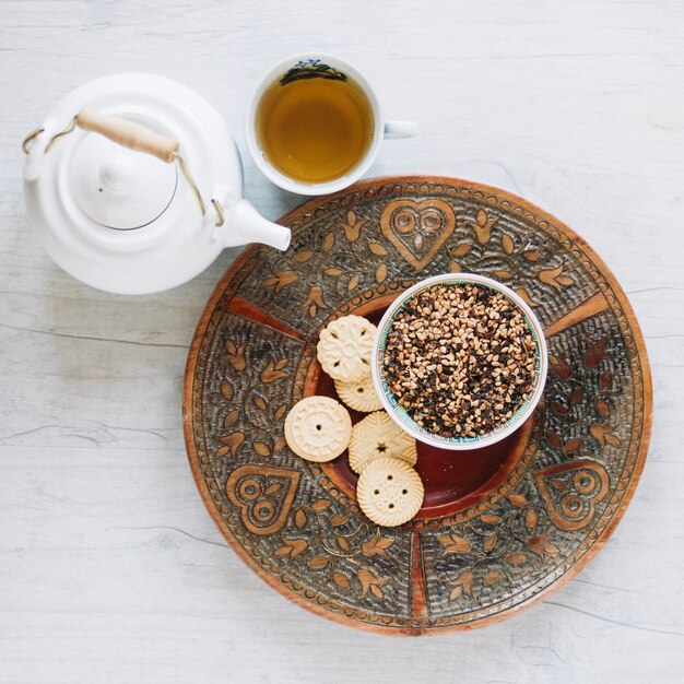 Aromatic tea and tasty dessert on tray