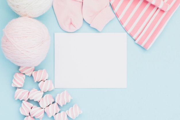 Arranged baby clothes and greeting card