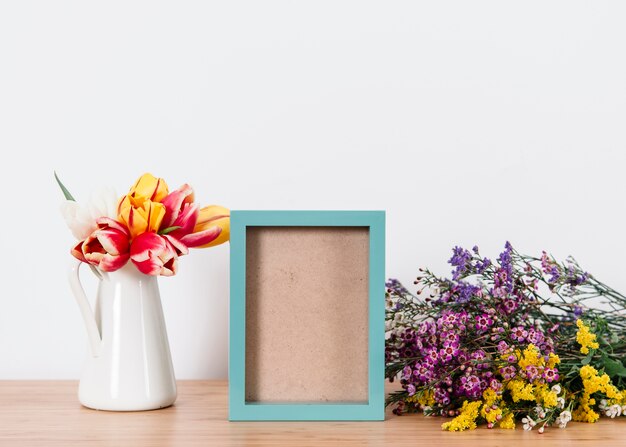 Arranged blue photo frame and flowers