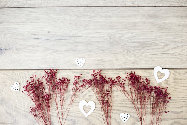 Free photo arranged dry branches with romantic hearts