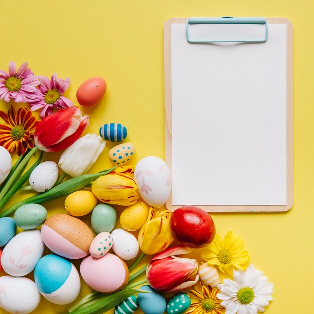 Arranged Easter eggs and clipboard