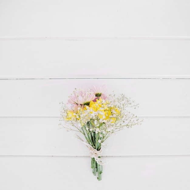 Arranged gentle bouquet on wood