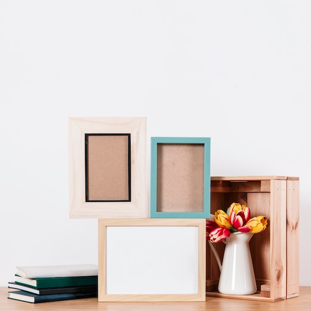 Arranged notepads with frames on table