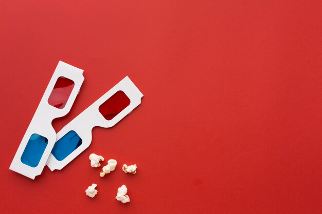 Arrangement of 3d glasses on red background with copy space