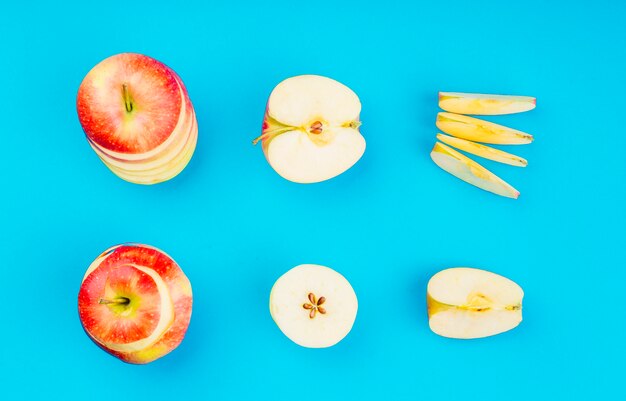 Arrangement of apple slices on blue background