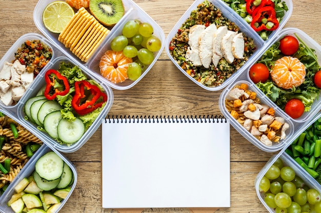 Arrangement of batch food cooked with empty notebook