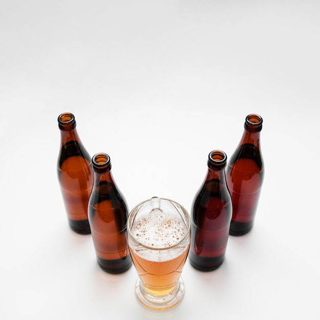 Arrangement of beer bottles with glass