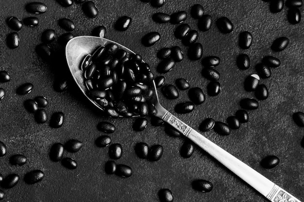 Arrangement of black beans on dark background