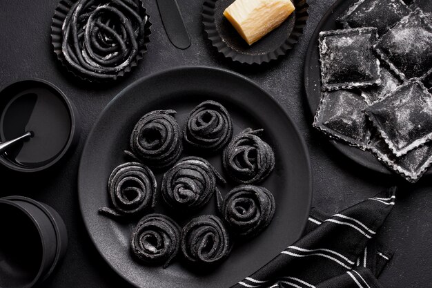 Arrangement of black delicious foods on dark table