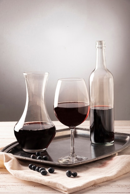 Free photo arrangement of bottles and glass of wine