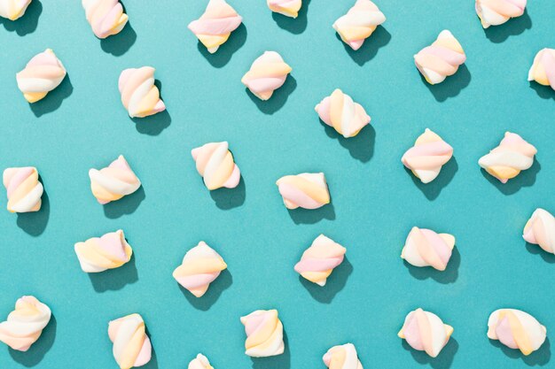 Arrangement of candies on blue background