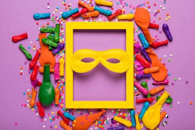 Free photo arrangement of carnival objects with yellow frame