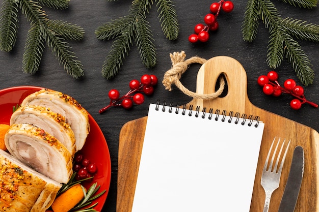 Arrangement of christmas food with empty notepad