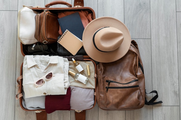 Free photo arrangement of clothes and accessories in a suitcase