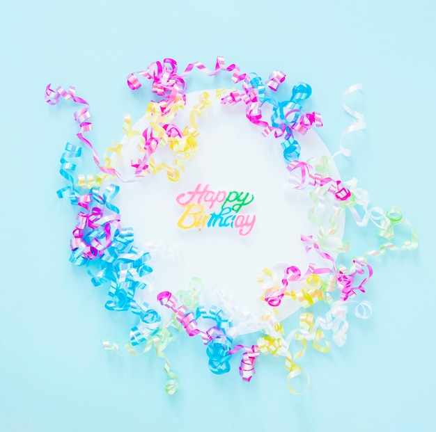 Arrangement of colorful confetti on blue background