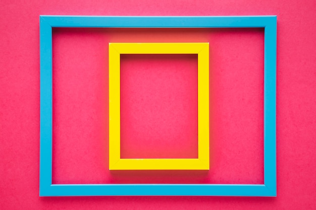 Free photo arrangement of colorful frames with pink background