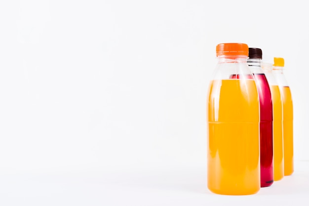 Arrangement of colorful juice in plastic bottles