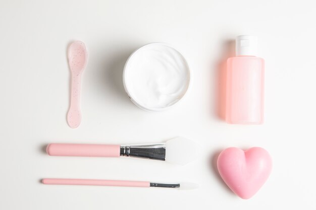 Arrangement of cosmetics on white background