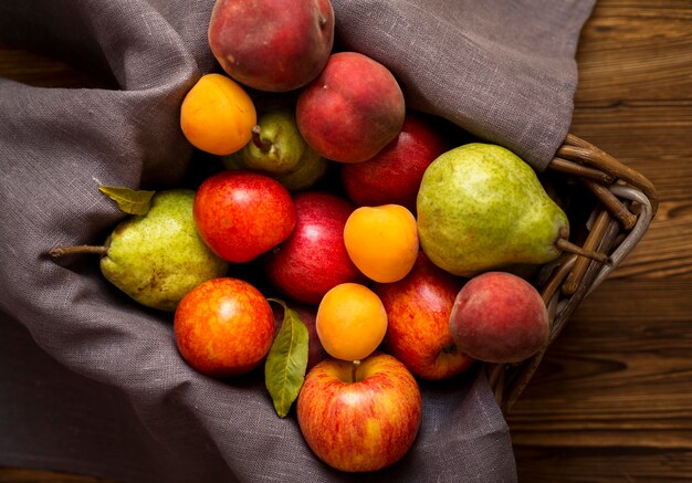 Arrangement of delicious autumnal fruits in basket