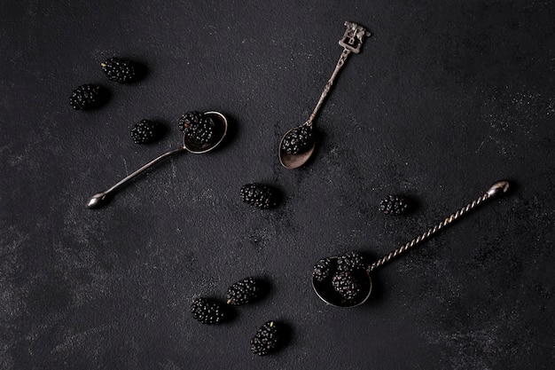 Arrangement of delicious blackberries in spoons