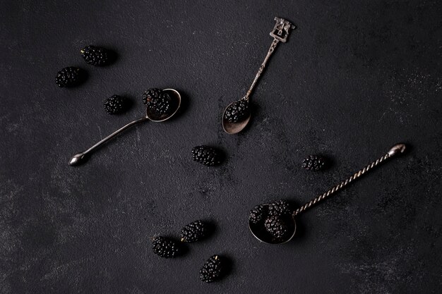 Arrangement of delicious blackberries in spoons