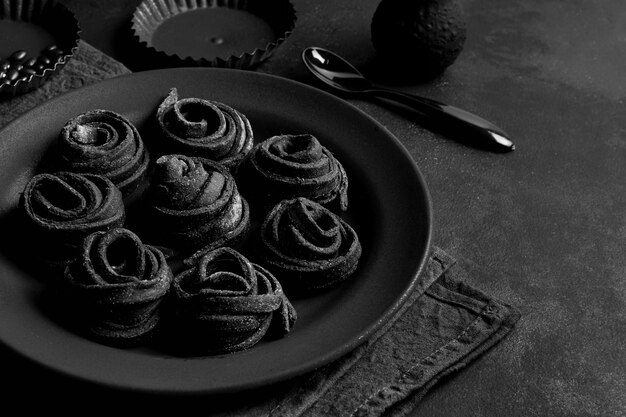 Arrangement of delicious food on dark plate and table