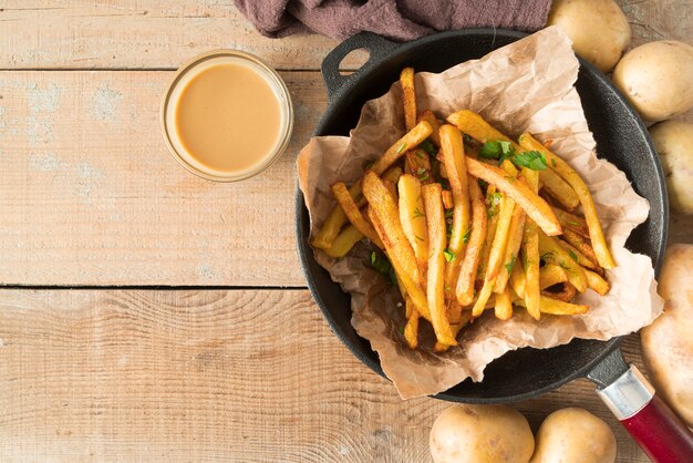 Arrangement of delicious potato fries in grey plate