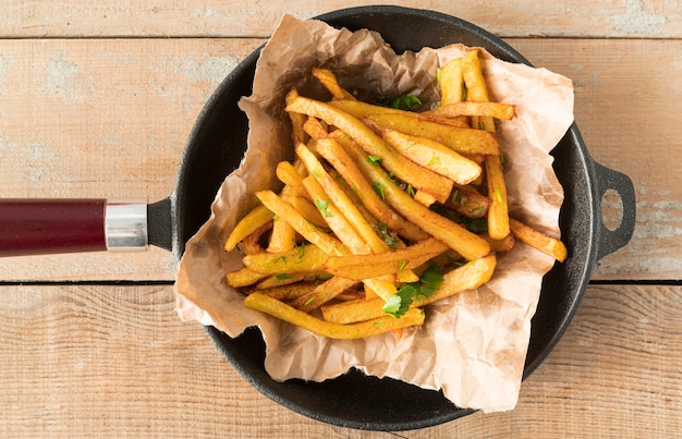 Arrangement of delicious potato fries in pan